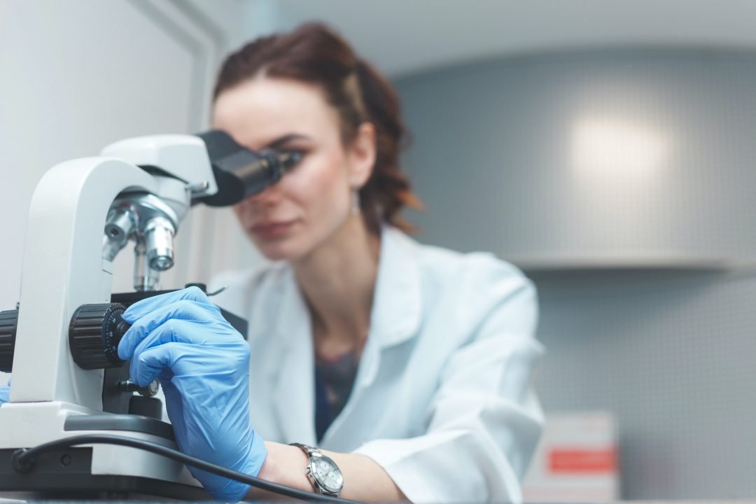 woman-scientist-researching-with-microscope-in-laboratory.jpg
